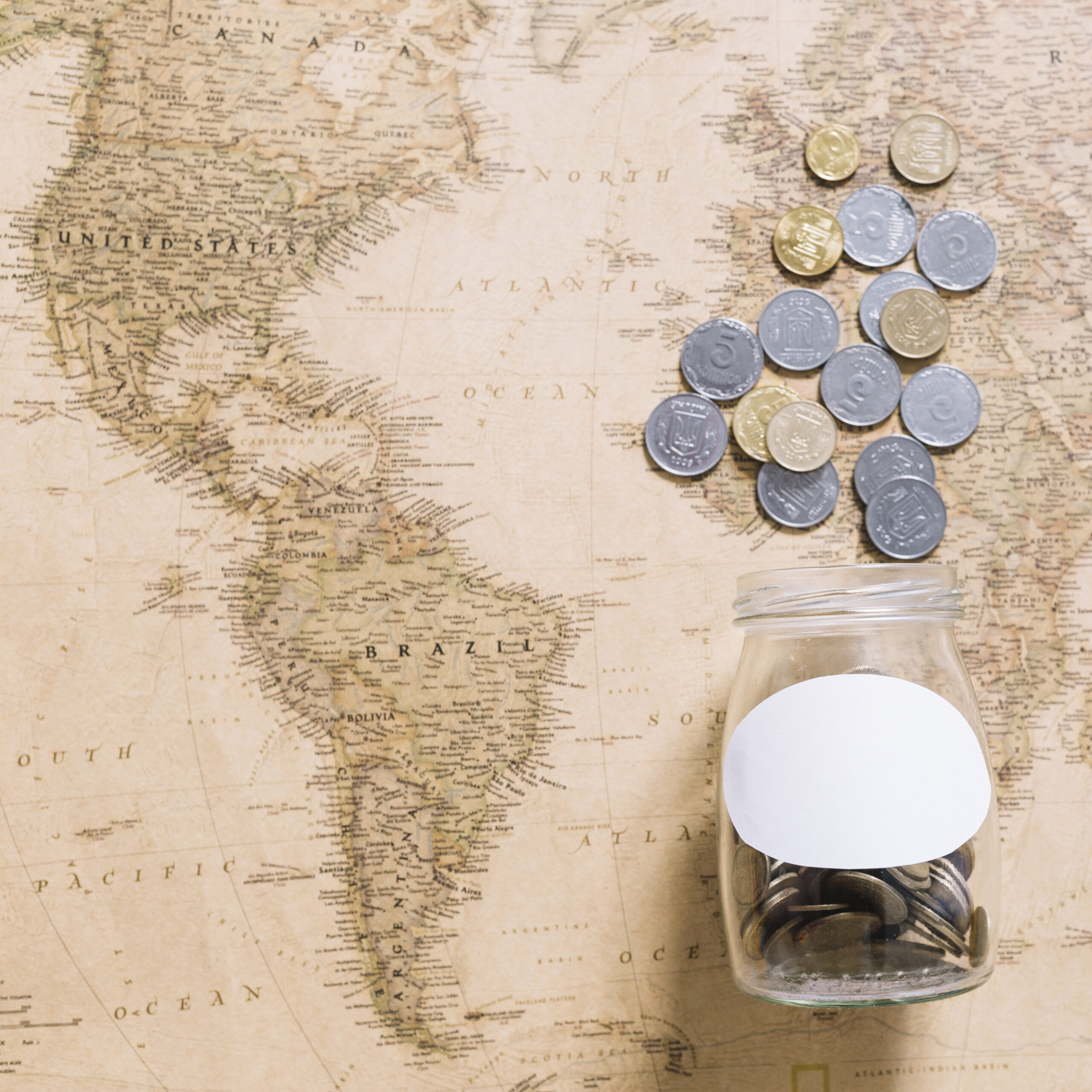 coins-spilling-from-jar-world-map